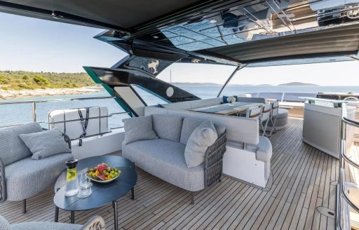 Luxury yacht charter ASCEND flybridge overview with seating and table