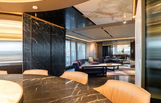 Circular dining area with wooden seating onboard charter yacht RAJA²