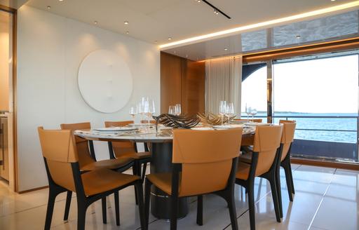 Dining table and chairs in the interiors of charter yacht A SALT WEAPON