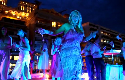 woman dancing on yacht during monaco grand prix after party