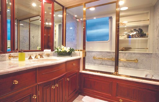 sumptuous and sophisticated His-and-hers bathroom inside the master deck of charter yacht Lady J