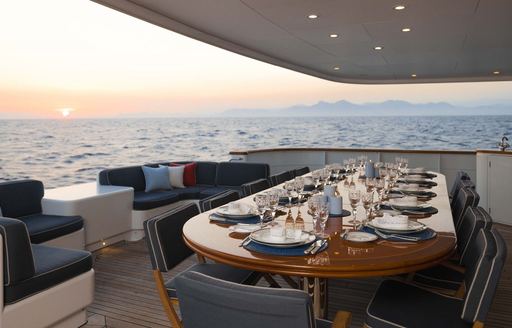 Alfresco dining table onboard charter yacht OLYMPUS