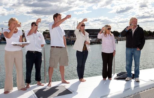 richard branson and crew celebrate catamaran necker belle's new name