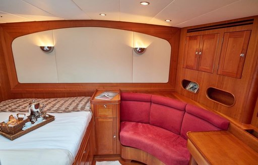 Guest cabin with circular bench seating onboard sailing yacht charter DARK STAR OF LONDON