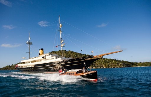 classic yacht NERO cruises on a luxury yacht charter alongside classic style tender