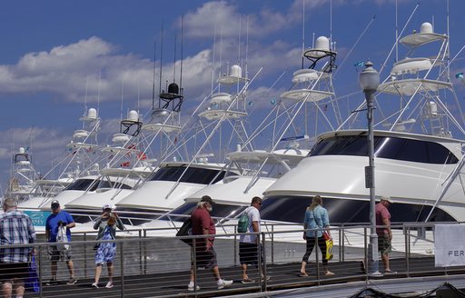 sportfishers at palm beach, with attendees walk past on bridge