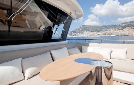 Exterior table and seating forward of the bridge onboard charter yacht ASLEC 4