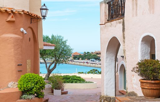 Town of Porto Cervo with harbour in background between houses