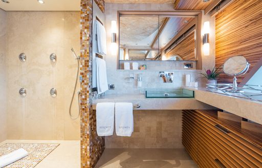 En suite facility with sink unit and shower onboard charter yacht SERENITY