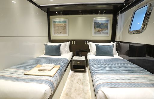 Twin cabin with two single berths and a small window onboard charter yacht ANDIAMO