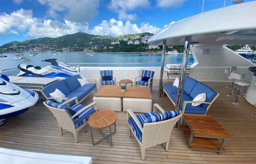 Comfortable seating and table on superyacht Chasing Daylight