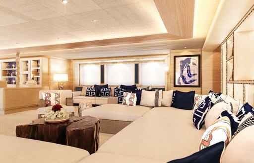 Main salon lounge area onboard charter yacht STARBURST IV, with white seating a blue scatter cushions