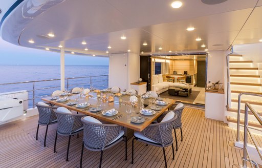 table set for dinner on upper deck aft of charter yacht NARVALO 