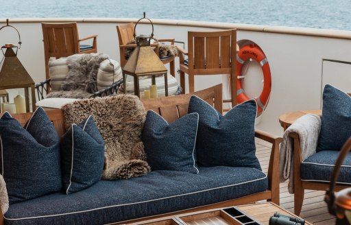 Charter yacht AQUA LARES exterior seating with blue cushions