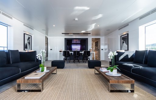 Overview of the main salon onboard charter yacht S7, with spacious lounge area in the foreground and dining aft. 