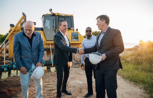 Francis Greenberger, David Mizrahi, Chris Barbe, Lelie Jasen Hodge with construction vehicle