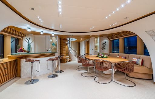 Interior dining area and wet bar onboard charter yacht SERENITY