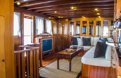 Wood furnished salon on charter yacht Over the Rainbow