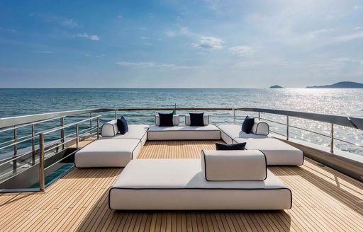 Exterior seating area surrounded by sea views onboard luxury charter yacht DON'T WORRY