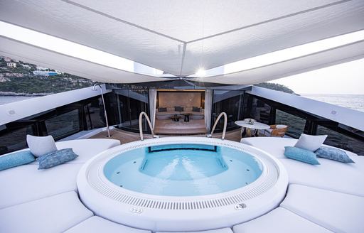 Jacuzzi surrounded by sunpads onboard charter yacht LUNA