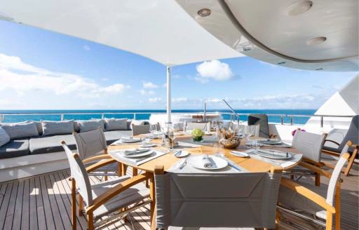 Exterior dining area onboard charter yacht BRAVADO
