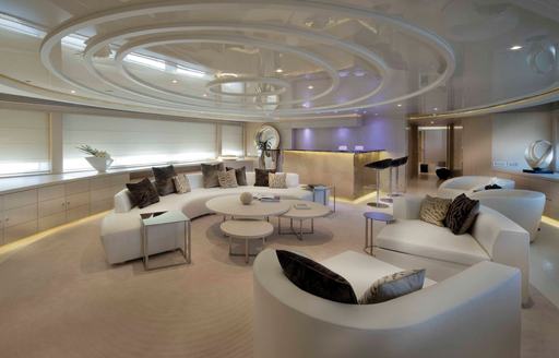 Upper salon lounge with plush white seating onboard charter yacht ELENI