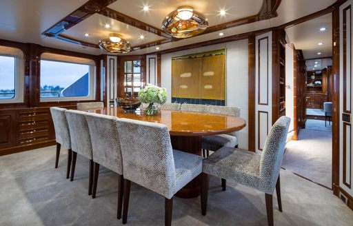 Dining table and gray seats onboard yacht charter SERENO