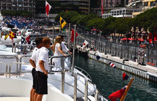  Monaco Grand Prix Yacht Charters and crew on deck watching race