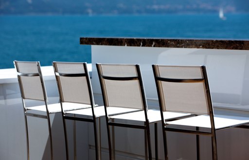 close up image of row of bar seating on luxury yacht zaliv iii