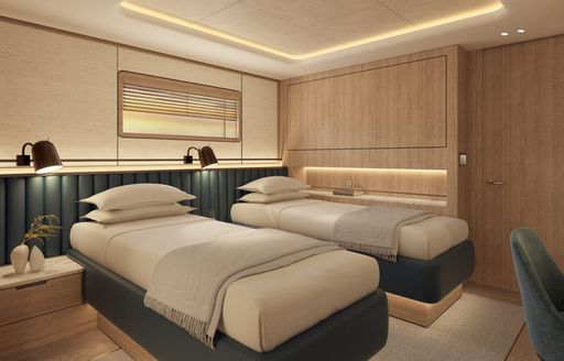 Twin cabin onboard charter yacht SEAWOLF X with two single berths with a chair in the foreground