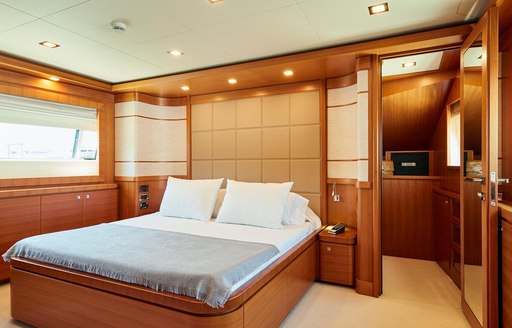 master suite with warm woods and central bed on board motor yacht DEVA