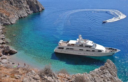 superyacht LIONSHARE anchors in secluded bay in the Mediterranean when on charter