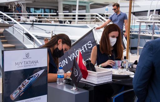 Staff sign visitors onboard MY Tatiana