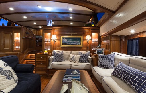 beautiful walnut lower salon with lounge area on board charter yacht MARAE