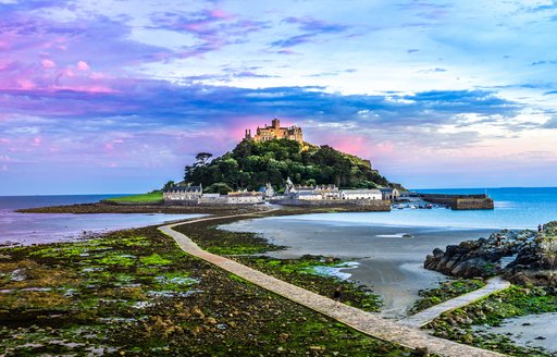 castle on the hill in cornwall, st michaels mount at low tide with sunset 