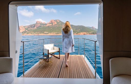 Charter yacht OWO fold-down balcony with charter guest