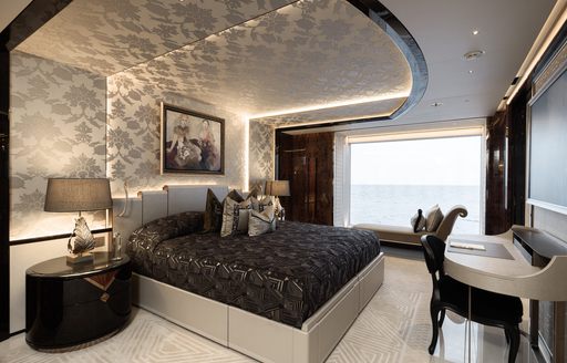 Luxurious guest cabin with double berth and large window onboard charter yacht KISMET