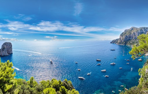 View across Caribbean sea with a number of yachts in bay of water