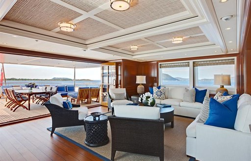 the more casual lounging space inside the upper deck salon of charter yacht fabulous character with bright big windows that flood the space with beautiful light