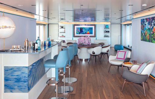 Interiors onboard charter yacht RIO with forward wet bar and dining area aft