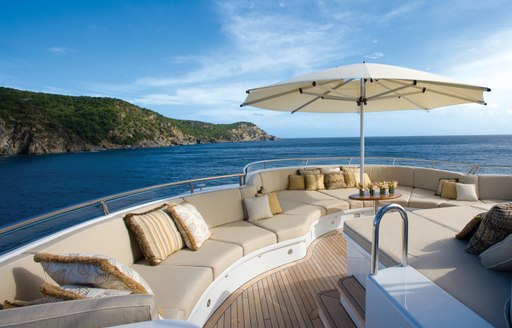 Charter yacht UTOPIA's sundeck with sofa seating, sunpads and views over the Caribbean islands