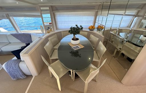Charter yacht LADY AMANDA interior dining area with oval table