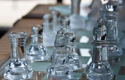 a set of clear glass chess pieces that guests can play while they enjoy their alone time on their luxury charter while also social distancing from high risk  spaces 