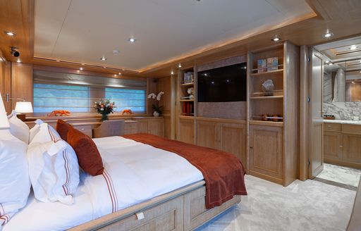 Overview of the master cabin onboard charter yacht LADY I with central berth and wall-mounted TV