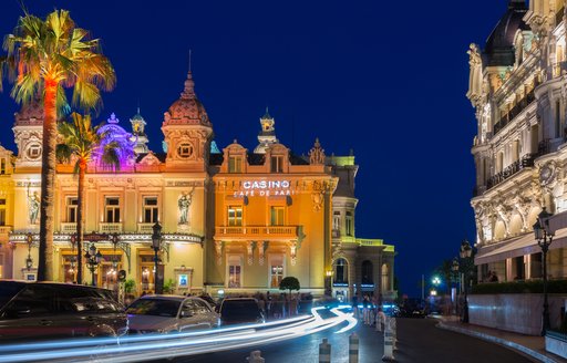 Evening image of Casino Cafe de Paris Monaco, lit up against night sky.