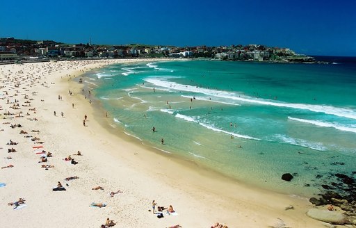 Aerial view of Bondi Beach with blue surf and people sunbathing