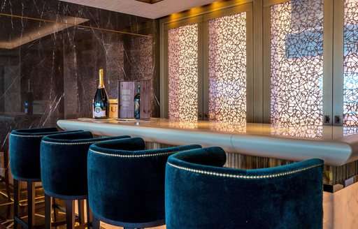 Wet bar and plush stools onboard charter yacht RENAISSANCE