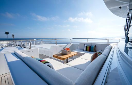 Exterior seating with central table onboard charter yacht KAISER
