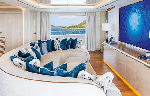 Super yacht charter AMOR A VIDA interior seating and large TV