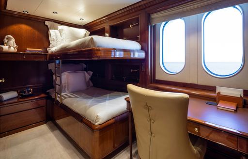 Bunk cabin with two single berths and dual windows onboard charter yacht STARFIRE